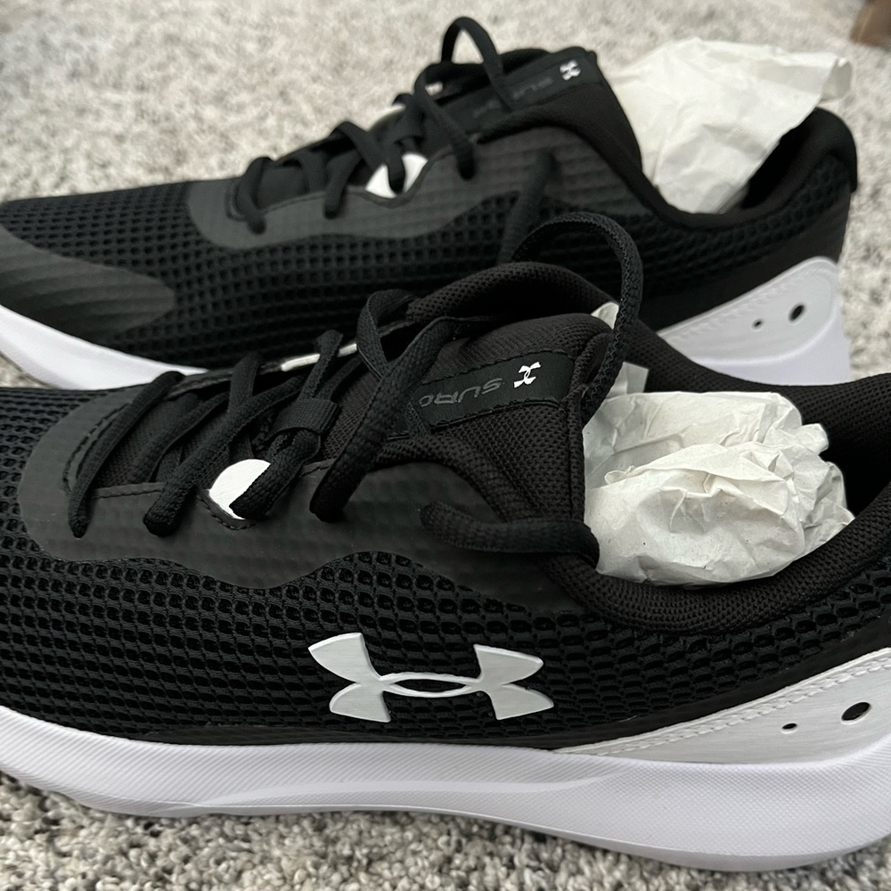Black and white under armor running shoes